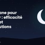 Plante de valériane en fleurs et flacon sur une table de chevet le soir